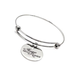 May include: A silver bangle bracelet with a round charm that says "Always Rejoice" and "Phil 4:4".