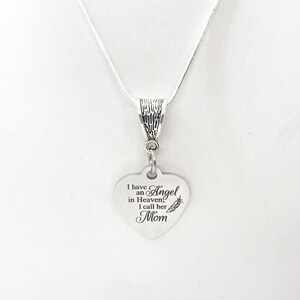 May include: Silver necklace with a heart-shaped pendant that reads "I have an Angel in Heaven, I call her Mom".