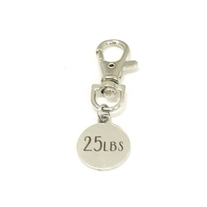 May include: Silver keychain with a round tag that says "25 LBS".