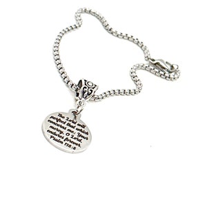 May include: Silver necklace with a round pendant featuring an engraved bible verse: "The Lord will perfect that which concerns me: Your mercy, O Lord, endures forever. Psalm 138:8"
