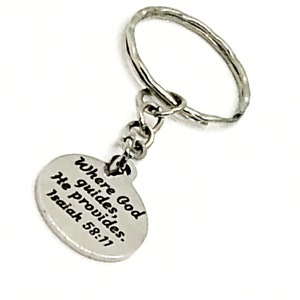 May include: Silver keychain with a round charm that reads "Where God guides, He provides. Isaiah 58:11"