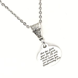 May include: A silver necklace with a round pendant that says "For the Lord your God goes with you. He will never leave you nor forsake you. Deuteronomy 34:6"