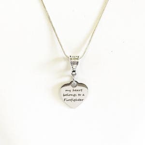 May include: Silver necklace with a heart pendant that says "my heart belongs to a Firefighter".