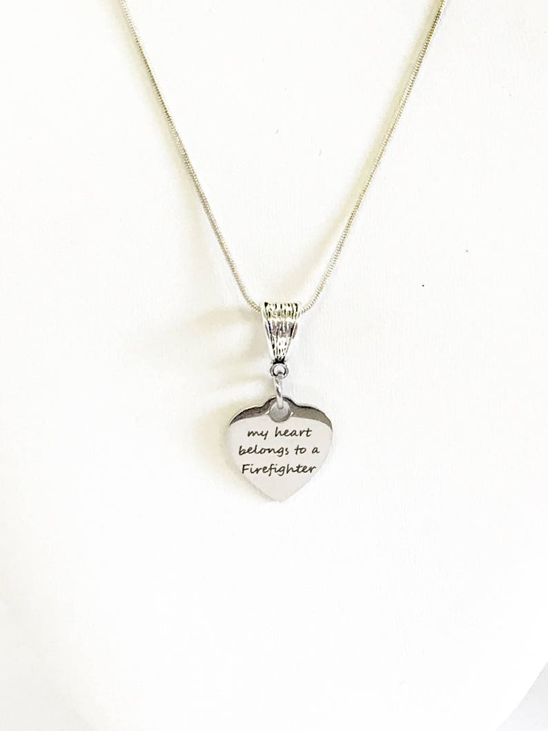 May include: Silver necklace with a heart pendant that says "my heart belongs to a Firefighter".