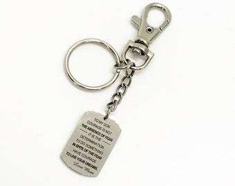 May include: Silver keychain with a silver tag that reads "To my son, courage is not the absence of fear, it is the determination to do something in spite of the fear. Have courage to live your dreams. Love Mom."