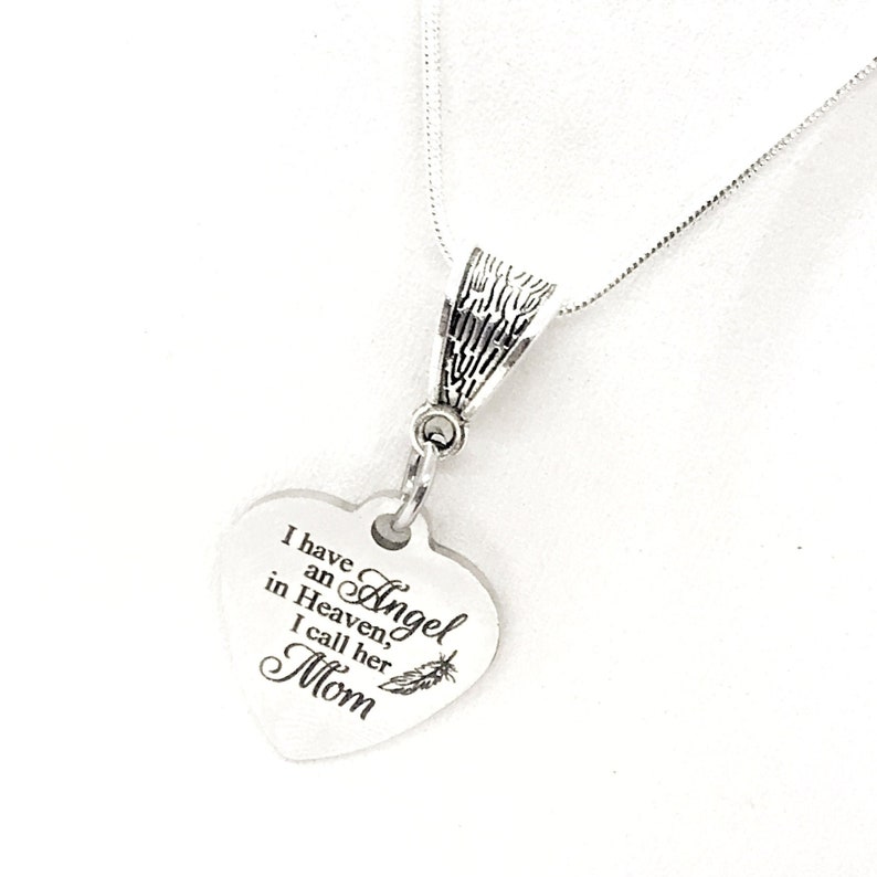 May include: Silver necklace with a heart-shaped pendant that reads "I have an Angel in Heaven, I call her Mom".
