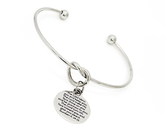 May include: A silver bangle bracelet with a knotted charm. The charm has an inscription that reads "The Lord bless you and keep you; The Lord make His face shine on you and be gracious to you; The Lord turn His face toward you and give you peace. Numbers 6:24-26"
