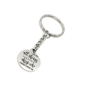 May include: Silver keyring with a round charm that says "I can do all things through Christ who strengthens me".