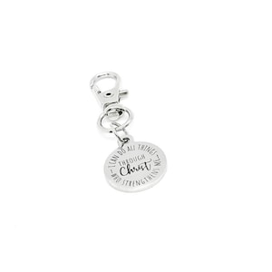 May include: A silver-colored keychain with a round charm. The charm has the text "I CAN DO ALL THINGS THROUGH CHRIST WHO STRENGTHENS ME" in a circular pattern. The keychain has a clasp for easy attachment.