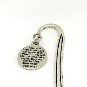 May include: Silver bookmark with a round charm featuring the text "Those who hope in the Lord will renew their strength. They will soar on wings like eagles; they will run and not grow weary. Isaiah 40:31"