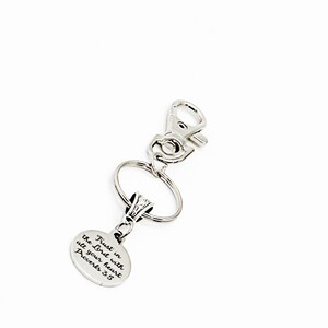 May include: Silver keychain with a round charm that says "Trust in the Lord with all your heart Proverbs 3:5"
