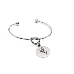 May include: Silver bangle bracelet with a knotted design and a charm featuring a delicate flower illustration.
