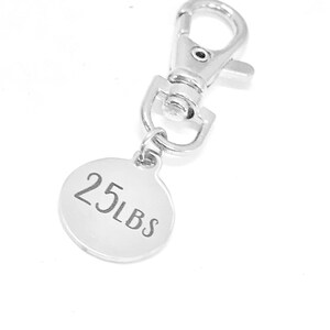 May include: Silver keychain with a round tag that says "25 LBS".