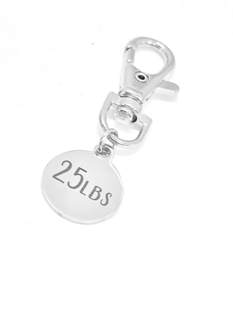 May include: Silver keychain with a round tag that says "25 LBS".