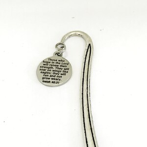 May include: Silver bookmark with a round charm featuring the bible verse "Those who hope in the Lord will renew their strength. They will soar on wings like eagles; they will run and not grow weary. Isaiah 40:31"