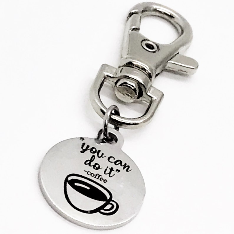 May include: Silver keyring with a round charm that says "You can do it - coffee" with a coffee cup graphic.