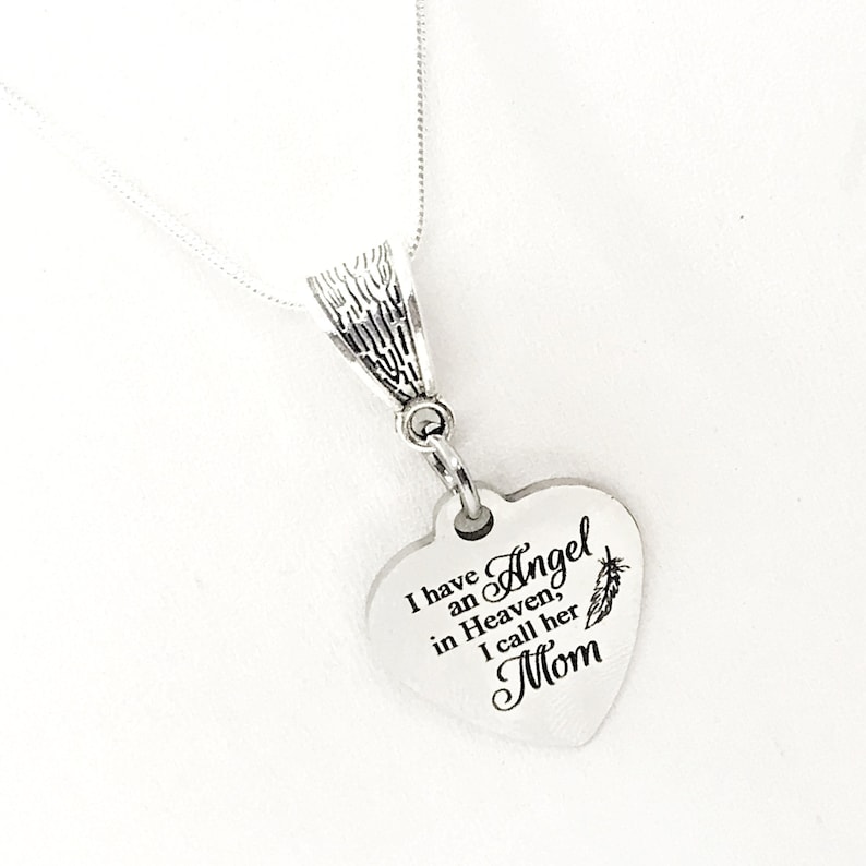 May include: Silver necklace with a heart-shaped pendant that reads "I have an Angel in Heaven, I call her Mom".
