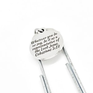 May include: Silver bookmark with a round charm that says "Whatever you do or say, do it as a representative of the Lord Jesus. Colossians 3:17".