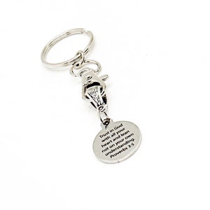 May include: Silver keychain with a round charm that reads "Trust in God with all your heart and lean not on your own understanding. Proverbs 3:5".