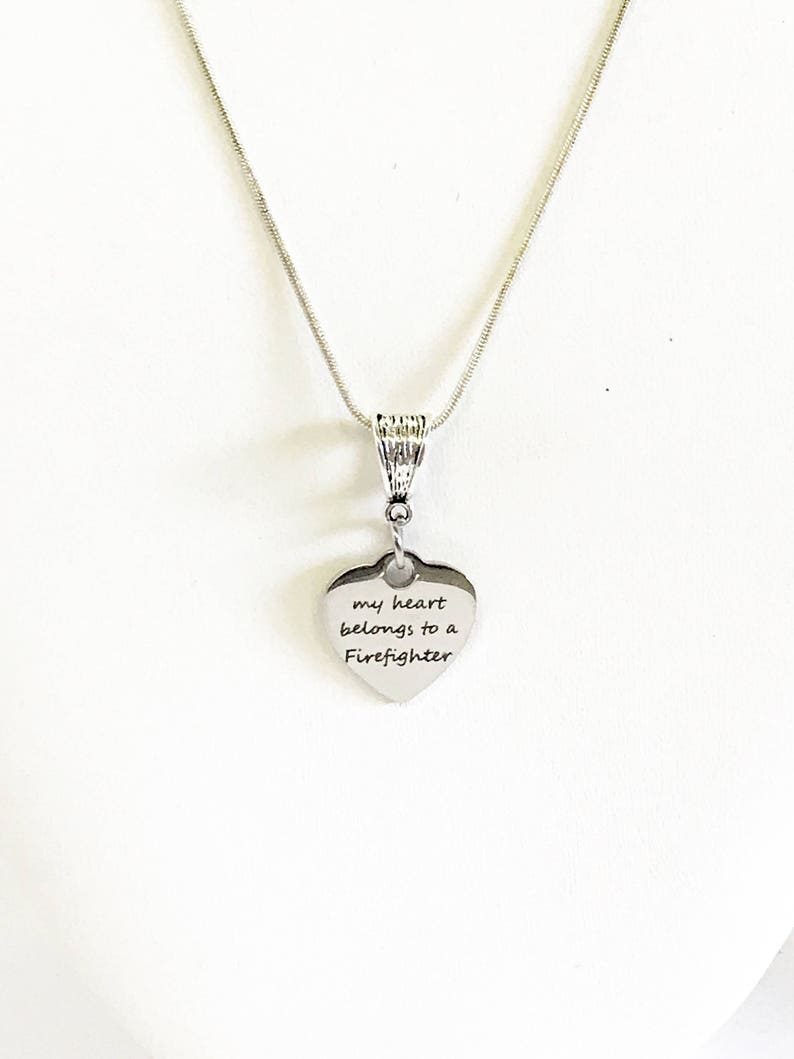 May include: Silver necklace with a heart pendant that says "my heart belongs to a Firefighter".