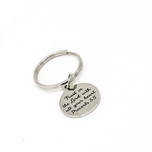 May include: Silver keychain with a round charm that says "Trust in the Lord with all your heart. Proverbs 3:5"