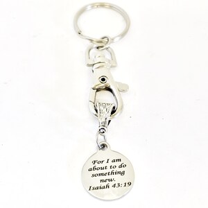 May include: Silver keychain with a silver clip and a round tag that says "For I am about to do something new. Isaiah 43:19"