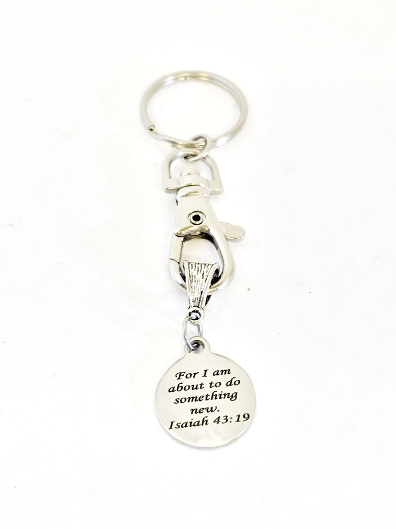 May include: Silver keychain with a silver clip and a round tag that says "For I am about to do something new. Isaiah 43:19"