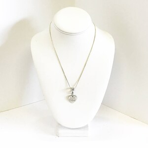 May include: A silver chain necklace with a heart-shaped pendant that reads "My sister is my soulmate, my forever friend".