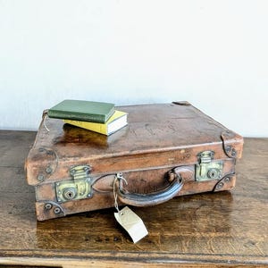 A vintage leather suitcase - a compact,  hide C1920s leather suitcase