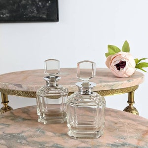 A pair of exquisite Art Deco antique cut glass scent bottles with solid silver mounts,  Hallmarked London 1932/33