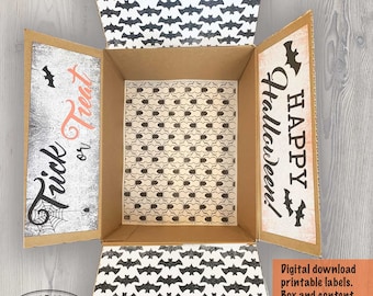 May include: An open cardboard box featuring decorative Halloween-themed interior panels. The top and bottom flaps display a black bat pattern, while the side panels feature the text Trick or Treat and Happy Halloween with spider web motifs.