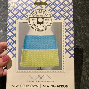 May include: A sewing apron kit featuring a blue and yellow patterned apron design. The packaging includes the text "The Great British Sewing Bee" and "Sew Your Own Sewing Apron". Suitable for intermediate sewers.
