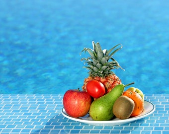 Plastic placemat fruit in front of the pool