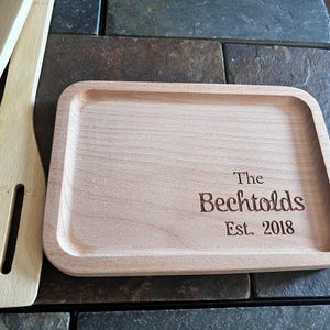 May include: A light brown wooden serving tray with the text "The Bechtolds Est. 2018" engraved on the surface.