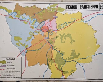 May include: A vintage map of the Paris region, featuring a colorful design with various zones in shades of yellow, orange, pink, and blue. The map includes labeled areas for forests, airports, and highways, with the text "REGION PARISIENNE 23" at the top.