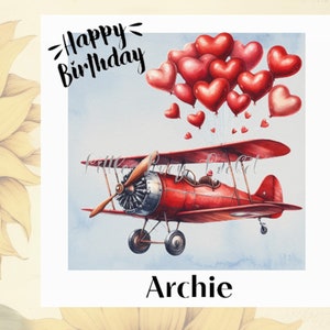 May include: A red biplane illustration with heart-shaped balloons floating above. The image includes the text "Happy Birthday" and the name "Archie". The biplane has a propeller and is set against a light blue sky.
