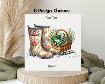 May include: A square sign featuring the text 6 Design Choices, Your Text, and Name. The illustration displays a pair of cream-colored rain boots with a pink and blue floral pattern, a woven basket containing green gloves and shears.