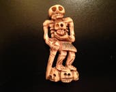 Carved Bone Bead with Skeleton and Heads