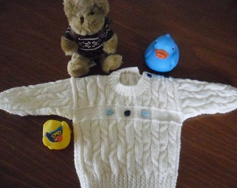 Child's cable knit sweater in Aran acrylic yarn.