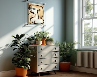 May include: A light gray four-drawer chest with tapered wooden legs, topped with three potted green plants. Above the chest hangs a framed abstract line drawing of a figure in a clear acrylic mount on a light blue wall near a window.
