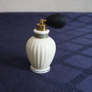 Vintage perfume bottle with spray dispenser.
