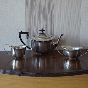 Vintage silver plate 3- piece tea set with the teapot, sugar bowl and milk jug.