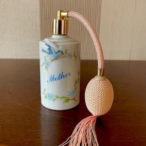 Vintage glass perfume bottle with a spray dispenser.