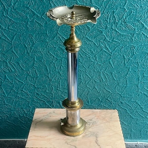 Vintage shiny metal ashtray stand, vintage ashtray with an eagle and tiger decoration at the base.