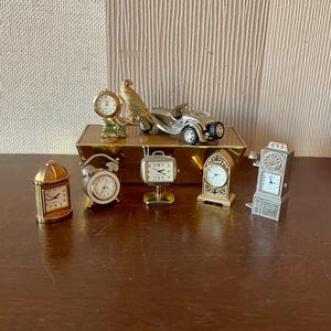Set of 8 vintage miniature quartz clocks for restoration, spare or repair.