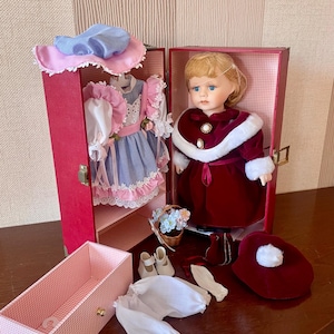 Vintage porcelain doll with its own wardrobe with drawer, hangers, clothes and accessories.