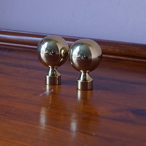 Vintage brass curtain rod ends.