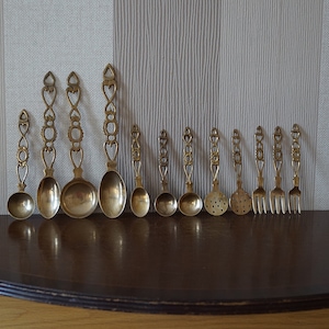 Set of 12 Vintage brass kitchen tools: 3 big spoons, 4 small spoons 3 forks and 2 strainers.