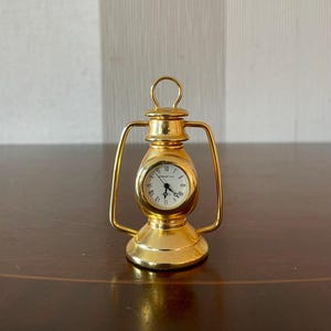 Vintage miniature oil lamp quartz clock, vintage desk clock good working.