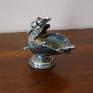 Antique silver plated sugar bowl with two scoops.